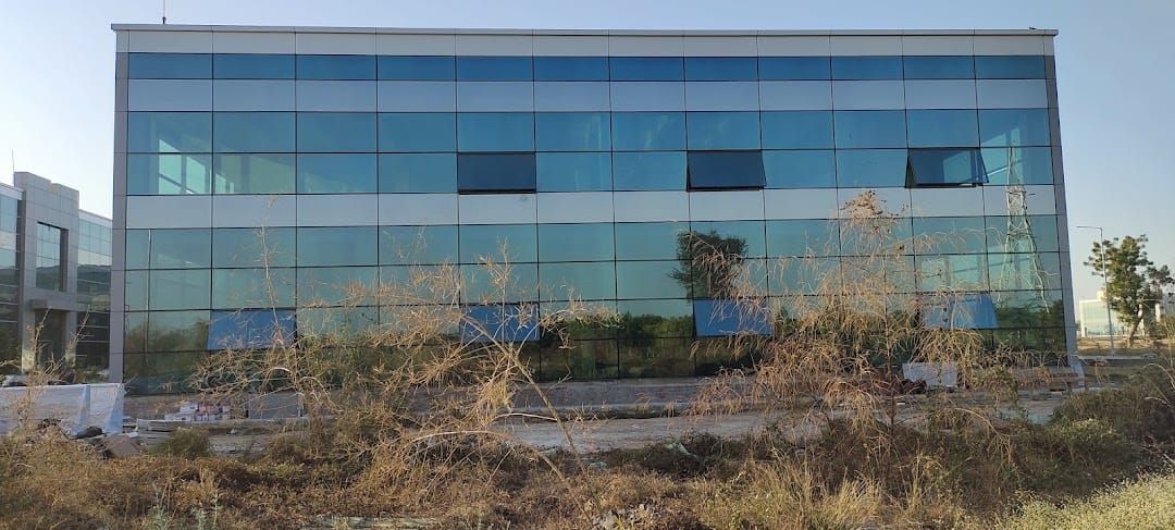 Blue reflective curtain wall glazing at Asahi India Glass, Mehsana
